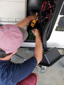 RV Technician Replacing RV Battery